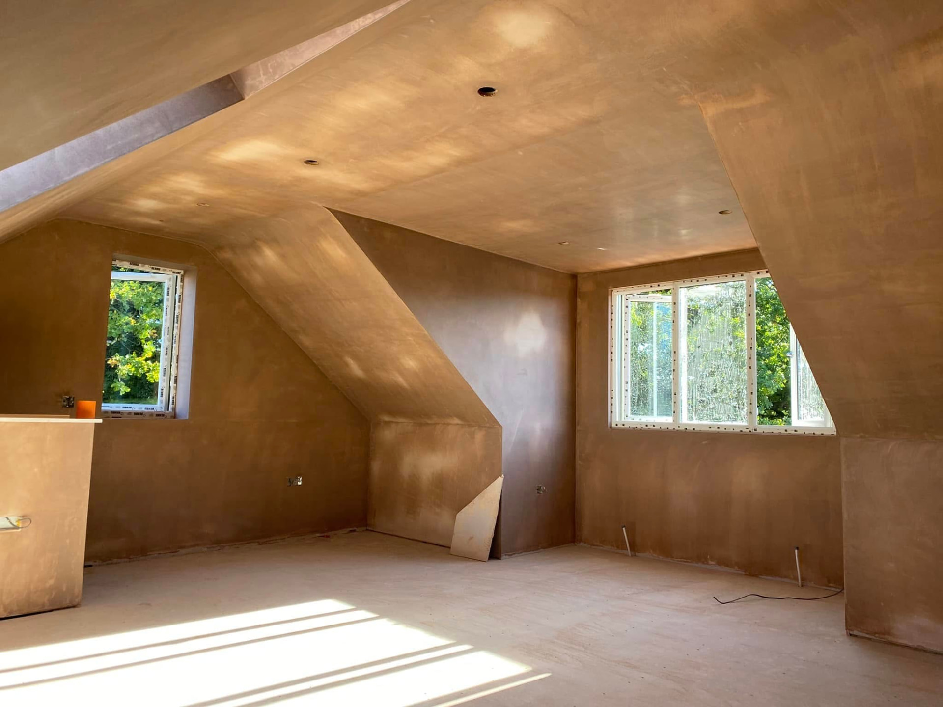 Interior construction work showing a newly plastered room