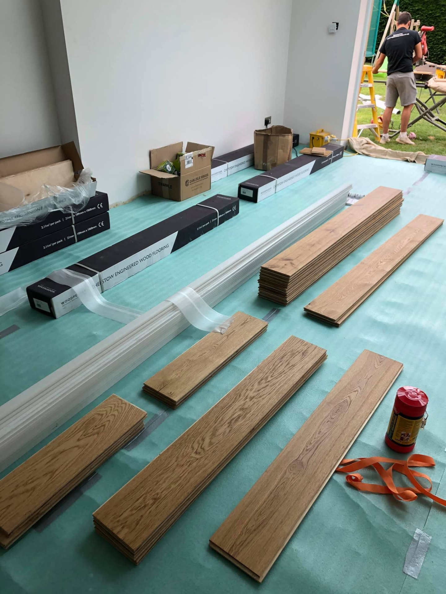 Engineered wood flooring being laid during an ongoing project